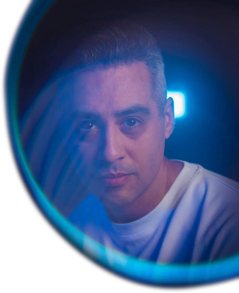 Jacob Terrazas photographed through a blue-lit circular mirror